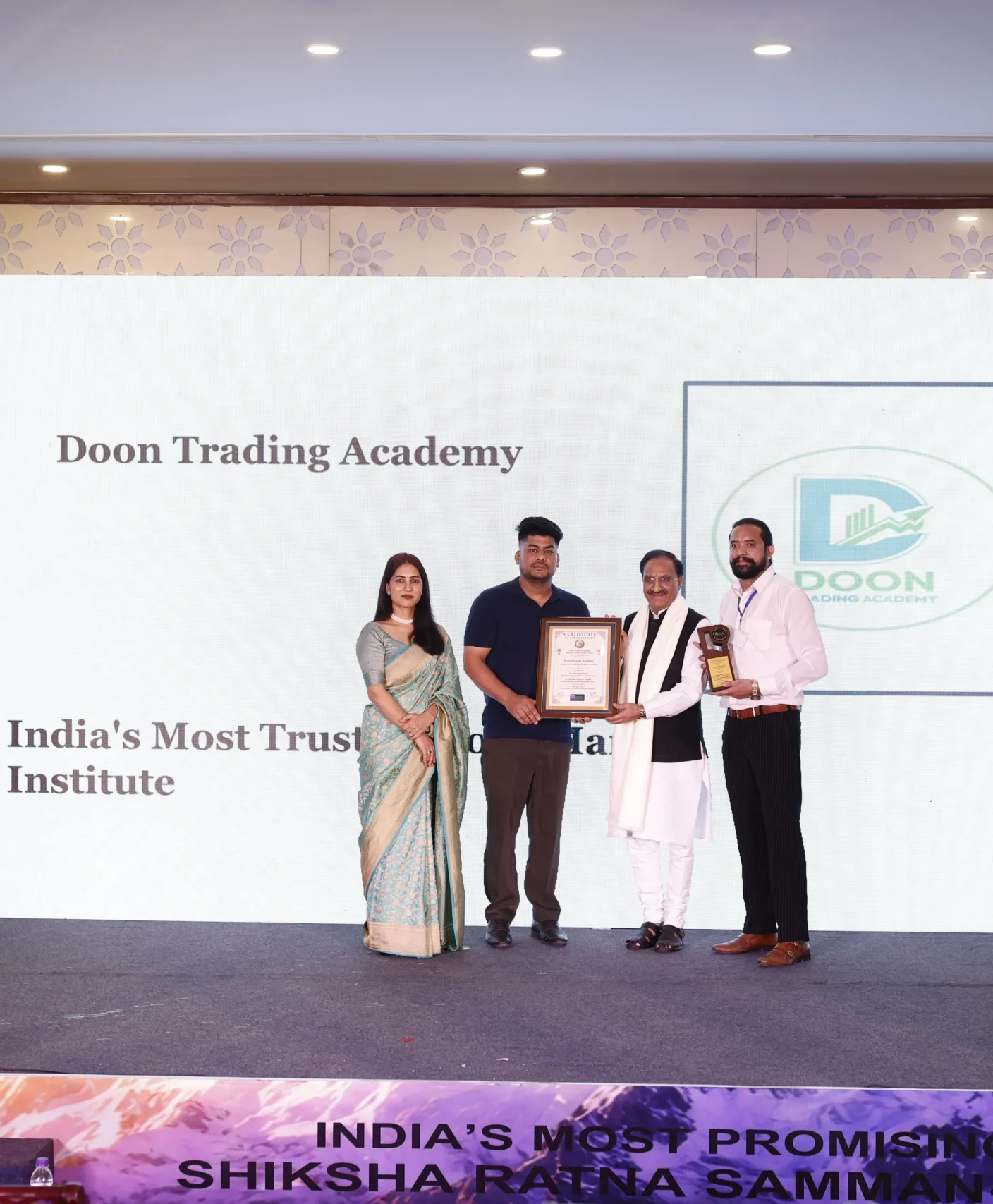 image of getting award from former cm of uttarkhand, in the image there is CM , and founder and co founders